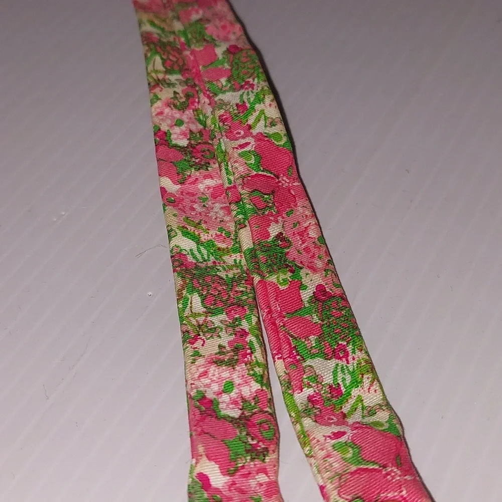 Lilly Pulitzer floral sunglass strap with pink and green colors.
